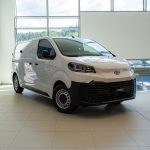 1M - TOYOTA OURENSE White Toyota Proace van on a bright showroom floor, shown in a front three-quarter view.